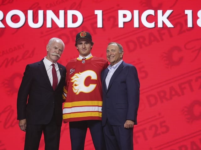 Cole Reschny, middle, stands with Lanny McDonald, left, and NHL commissioner Gary Bettman after being drafted by the Calgary Flames during the NHL hockey draft Friday, June 27, 2025, in Los Angeles.