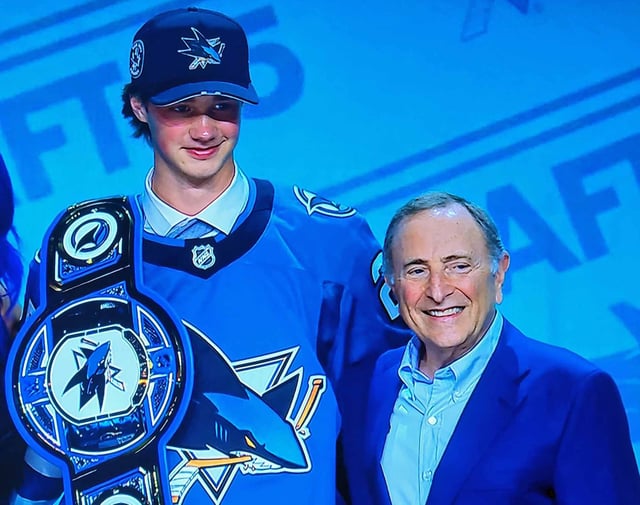 Prince George Cougars goalie Joshua Ravensbergen poses on the stage with NHL commissioner Gary Bettman after he was selected 31st overall by the San Jose Sharks in Friday;s NHL draft.