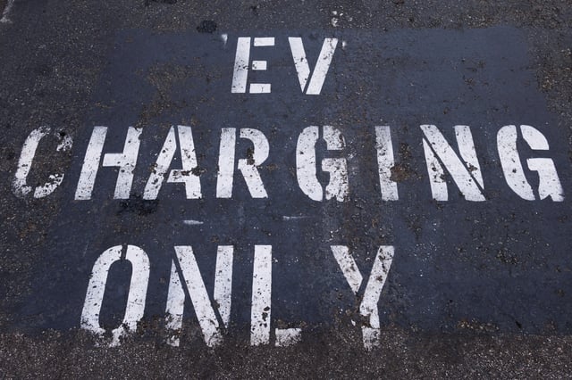 A parking space is marked specifically for an electric vehicle to charge charger in a shopping center parking lot in Oceanside, California, U.S.,October 19, 2023.     REUTERS/Mike Blake/File Photo