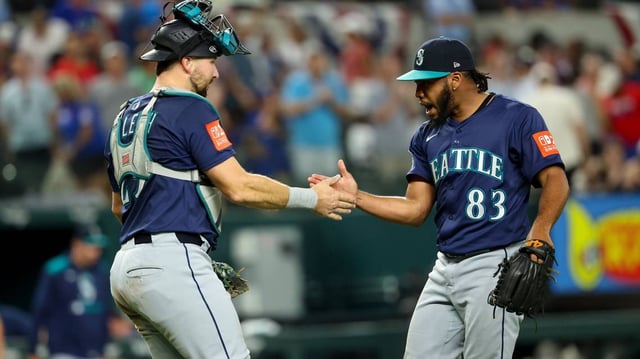 Seattle Mariners relief pitcher Eduard Bazardo (83) celebrates with catcher Cal Raleigh (29) after a win over the Texas Rangers on Friday at Globe Life Field in Arlington, Texas.