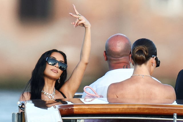 Kim Kardashian and Khloe Kardashian travel on a boat, on the second day of the wedding festivities of Amazon founder Jeff Bezos and journalist Lauren Sanchez, in Venice, Italy, June 27, 2025. REUTERS/Guglielmo Mangiapane