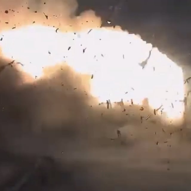 Debris scatters on June 26, 2025, during a static fire test of a new solid rocket motor at a Northrop Grumman facility in Utah. The motor is supposed to be used in later Artemis moon missions.