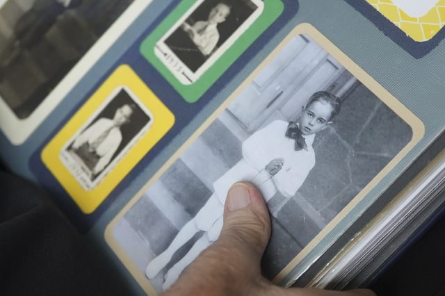 The Rev. James Kelly points to a portrait of himself during his First Communion during an interview at the Normandy Farms Estates retirement community in Blue Bell, Pa., on Wednesday, June 18, 2025. (AP Photo/Luis Andres Henao)