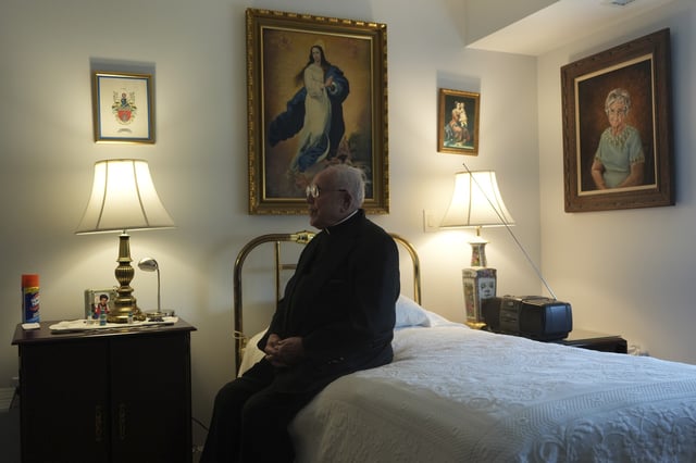The Rev. James Kelly sits in his apartment in the Normandy Farms Estates retirement community in Blue Bell, Pa., on Wednesday, June 18, 2025. (AP Photo/Luis Andres Henao)