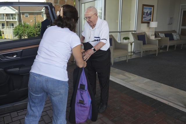The Rev. James Kelly takes off his Roman collar and gets ready to go to a doctor’s appointment in Blue Bell, Pa., on Wednesday, June 18, 2025. (AP Photo/Luis Andres Henao)