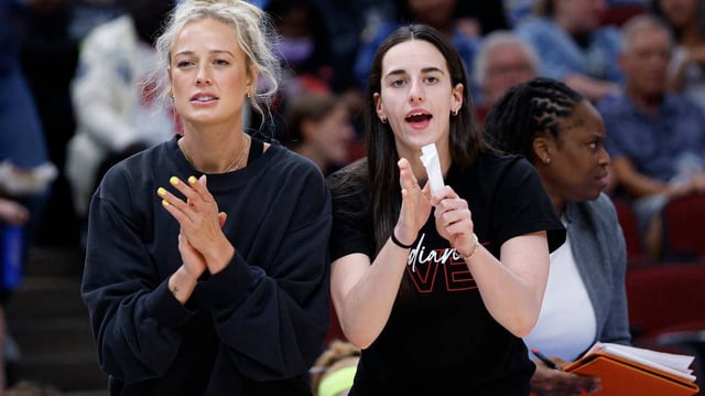 Jun 7, 2025; Chicago, Illinois, USA; Injured Indiana Fever guard Sophie Cunningham (8) and guard Caitlin Clark (22) react from the bench during the first half of a WNBA game against the Chicago Sky at United Center. Mandatory Credit: Kamil Krzaczynski-Imagn Images