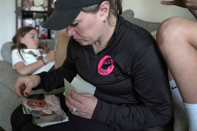 Katie Van Tornhout looks through photos of her late daughter, Callie, at home in Lakeville, Ind., on May 7, 2025. (AP Photo/Shelby Lum)