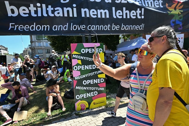 Participants pose for a selfie as they arrive to take part in the event despite a government ban.