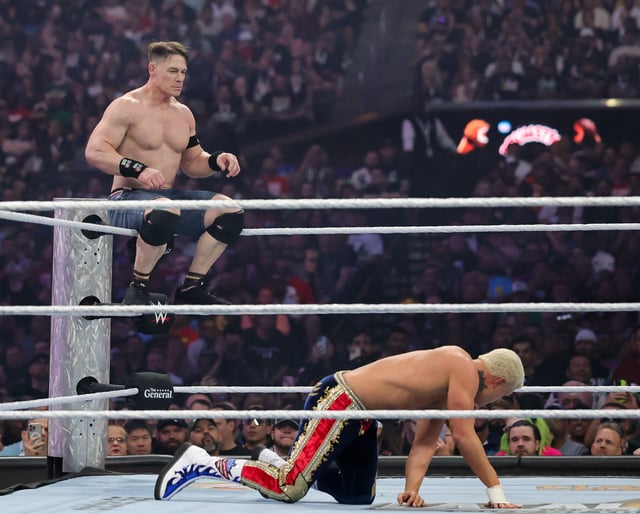 John Cena (L) sits on the top rope during his Undisputed WWE Championship match against Cody Rhodes during WrestleMania 41 at Allegiant Stadium on April 20, 2025 in Las Vegas, Nevada.