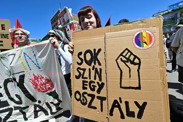 A participant poses with a placard reading &#39;Many colours are a class&#39; during the Budapest Pride march, on June 28, 2025 in Budapest, despite a governmental ban of the event.