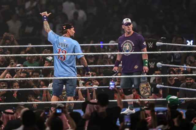 US wrestler John Cena (R) and US wrestler CM Punk stand in the ring during a presentation on the eve of their match for the undisputed WWE Championship at Kingdom Arena in Riyadh on June 27, 2025.