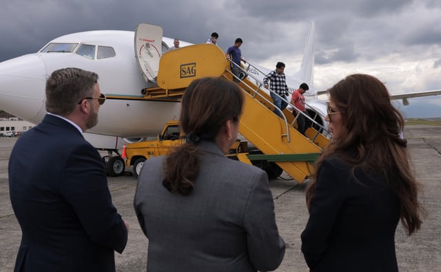 U.S. Homeland Security Secretary Kristi Noem, right, ERO Regional Attaché Guadalupe &#34;Lupita&#34; Serna and U.S. Ambassador to Guatemala Tobin Bradley watch people deported from the United States disembark a repatriation flight, at La Aurora International Airport in Guatemala City, Thursday, June 26, 2025.