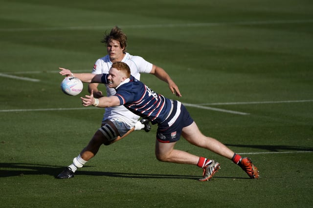 Harrison Boyle #10 of the New England Free Jacks reaches for the ball against Christian Poidevin #7 of the LA Giltinis during the second half at Los Angeles Coliseum on March 20, 2021 in Los Angeles, California. The inaugural game is the first for the LA Giltinis at the Los Angeles Coliseum.