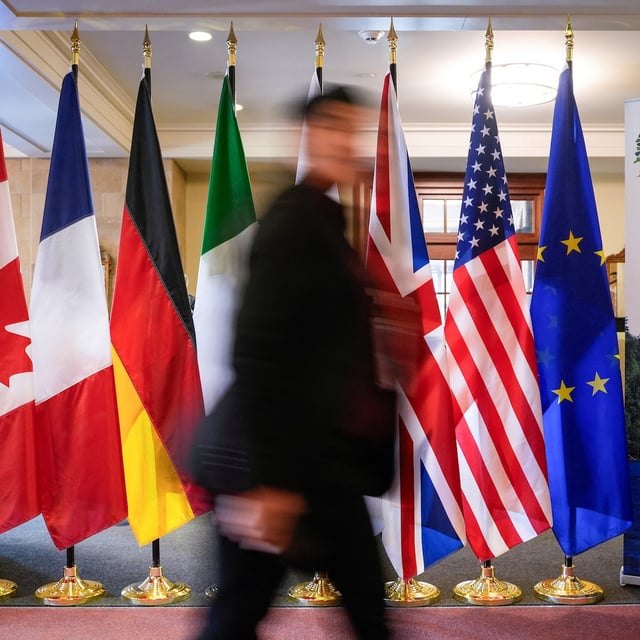 A man walk past the G7 members flags at the Manoir Richelieu before the G7 Foreign Ministers summit in La Malbaie, Que., in March.
