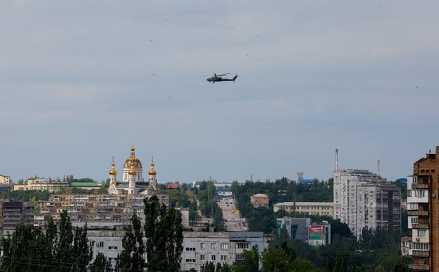 A Russian military helicopter flies past a flock of birds in the course of Russia-Ukraine conflict in Donetsk, a Russian-controlled city of Ukraine, June 28, 2025. REUTERS/Alexander Ermochenko