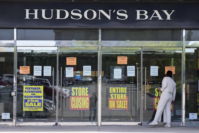 A person checks out the store closing advertising at the Hudson's Bay in Toronto, on Friday, May 30, 2025. 