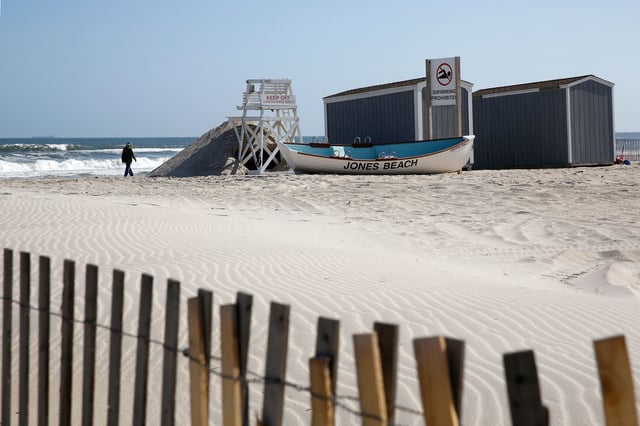 A person walks by the water at Jones Beach in Wantagh, New York, on May 21, 2020.