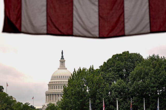 A U.S. flag is draped at Union Station with the U.S. Capitol dome in the background on the day of a meeting of U.S. Senators, as Republican lawmakers struggle to pass U.S. President Donald Trump’s sweeping spending and tax bill, on Capitol Hill in Washington, D.C., U.S., June 28, 2025. REUTERS/Ken Cedeno
