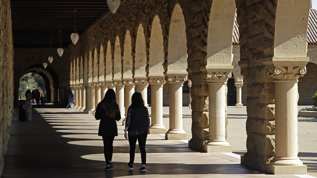 FILE – Students walk on the Stanford University campus, March 14, 2019, in Santa Clara, Calif. (AP Photo/Ben Margot, File)