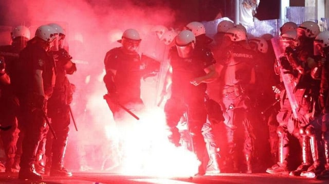 Protestors throw flares at riot police after a student-led anti-government demonstration in Belgrade, Serbia, on Saturday evening. Photo by Andrej Cukic/EPA