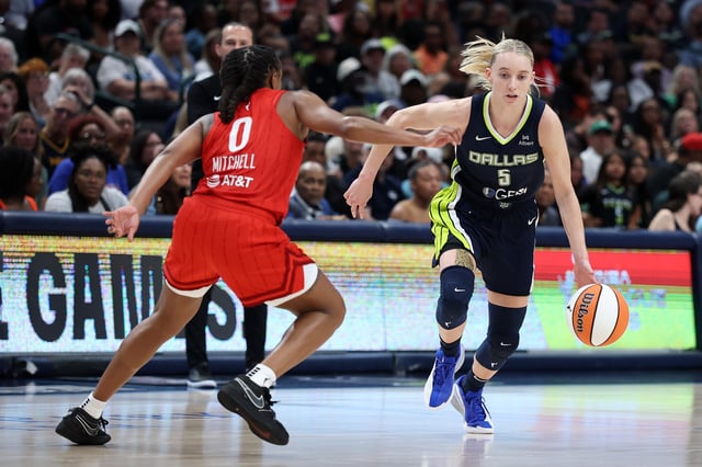 Paige Bueckers #5 of the Dallas Wings drives around Kelsey Mitchell #0 of the Indiana Fever during the second half of a game at American Airlines Center on June 27, 2025 in Dallas, Texas.