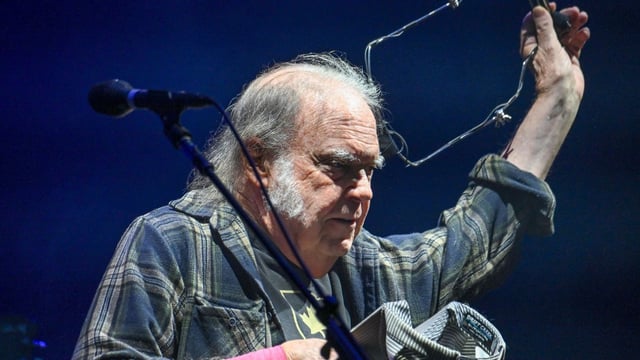 Neil Young in his faded plaid shirt on the Pyramid stage at Glastonbury
