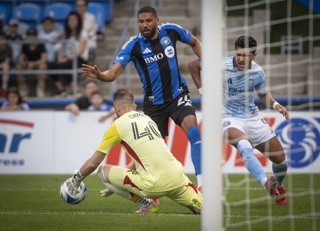 CF Montreal goalie Jonathan Sirois (40) stops the shot on the net by New York City FC's Monsef Bakrar (9)'s during first half MLS action In Montreal, Saturday, June 28, 2025. THE CANADIAN PRESS/Peter McCabe