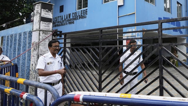 Policemen stand guard outside South Calcutta Law College after the rape of a student on the college campus. (Source: PTI)