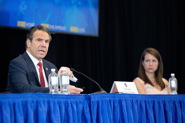Melissa DeRosa, then the secretary to the governor, right, listens as then-Gov. Cuomo speaks during his daily coronavirus press briefing at SUNY Upstate Medical University on April 28, 2020 in Syracuse, New York.