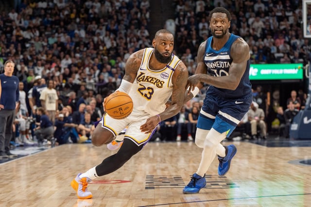 Los Angeles Lakers forward LeBron James (23) dribbles past Minnesota Timberwolves forward Julius Randle (30) in the second quarter during game four of first round for the 2025 NBA Playoffs at Target Center in Minneapolis, Minnesota on April 27, 2025.