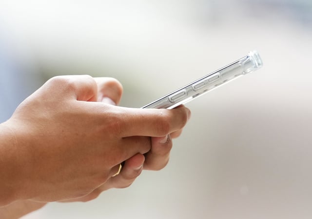 A person uses a cell phone in Ottawa on Monday, July 18, 2022. 