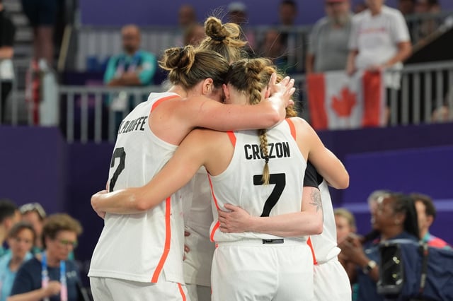 Canada's Katherine Plouffe (left to right), Michelle Plouffe Paige Crozon and Kacie Bosch huddle during the women's 3 X 3 basketball bronze medal game at the Summer Olympics in Paris on Monday, Aug.5, 2024. THE CANADIAN PRESS/Adrian Wyld