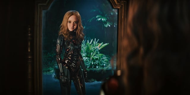 Amie Donald as M3GAN looking into a mirror in M3GAN  2.0