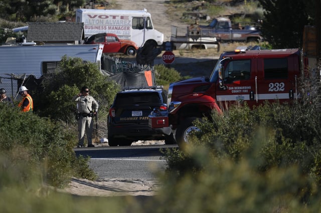 Authorities work at the scene of the Lake Fire, at Summit Valley Road and Highway 138 near Silverwood Lake, on Saturday, June 28, 2025.