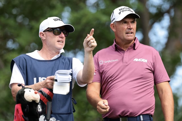 Padraig Harrington of Ireland and his caddie Ronan Flood plan a shot from the 18th tee during the third round of the U.S. Senior Open Championship 2025 at Broadmoor Golf Club on June 28, 2025 in Colorado Springs, Colorado.