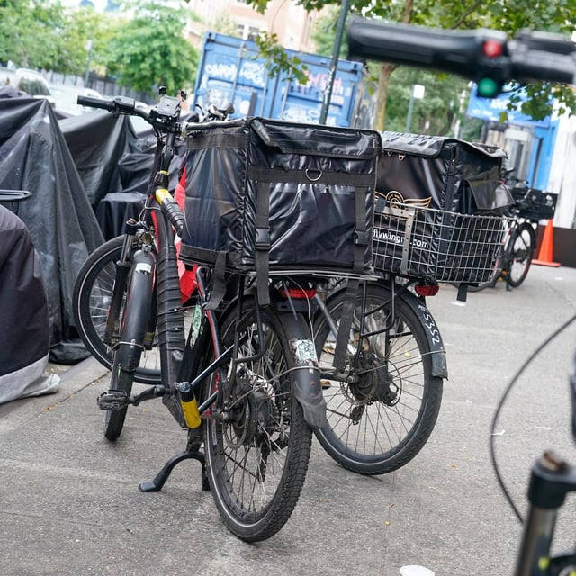Motorized bicycles are parked while delivery workers take a break in New York, Tuesday, July 25, 2023. THE CANADIAN PRESS/AP-Seth Wenig