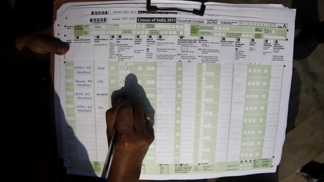 A census official collects information from a household in Guwahati in 2011.