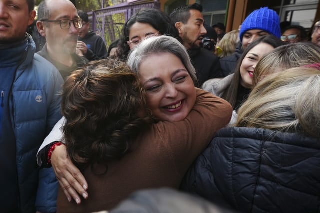 Candidate Jeannette Jara, of the Communist party, embraces supporters before voting in primary elections held by the Unidos por Chile coalition to choose the ruling party's candidate for the upcoming presidential election, in Santiago, Chile, Sunday, June 29, 2025. (AP Photo/Esteban Felix)