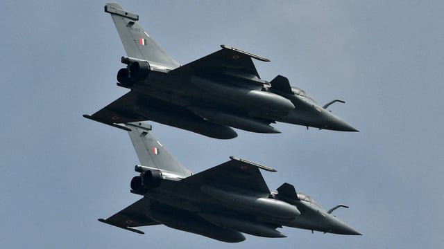 Indian Air Force's Rafale fighter jets fly past during the Aero India 2021 air show at Yelahanka air base in Bengaluru.