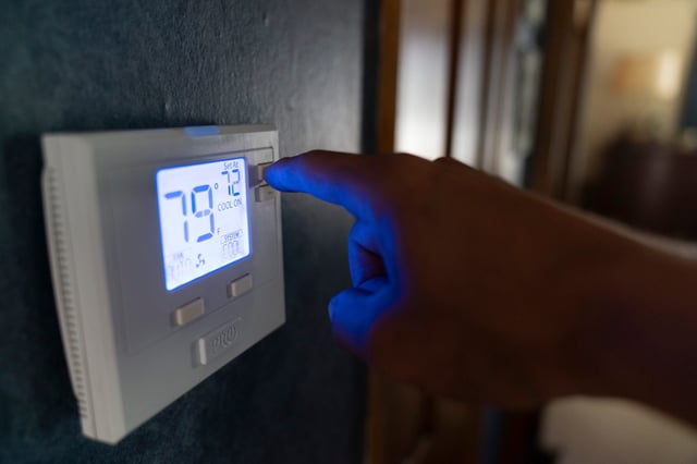 A thermostat is seen being adjusted during the summer months.