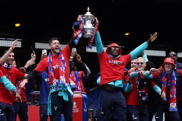 Soccer Football - FA Cup - Crystal Palace Victory Parade - Selhurst Park, London, Britain - May 26, 2025 Crystal Palace's Joel Ward and Marc Guehi hold the trophy with teammates during the Victory celebrations after winning the FA Cup Action Images via Reuters/John Sibley     TPX IMAGES OF THE DAY
