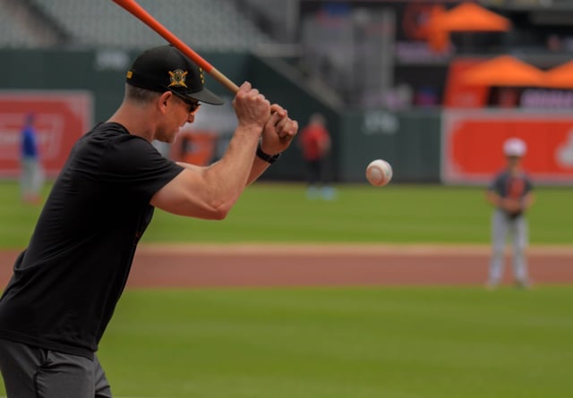 Baltimore Orioles third base coach Tony Mansolino hits grounders to his son Maddox during an interleague game of major league baseball at Oriole Park at Camden Yards. (Karl Merton Ferron/Staff)