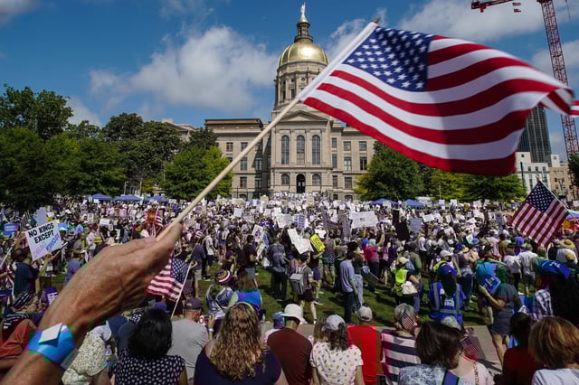 People take part in a &#34;No Kings&#34; protest at Liberty Plaza in Atlanta, Georgia, on June 14, 2025 as President Donald Trump presides over a military parade in Washington, DC.