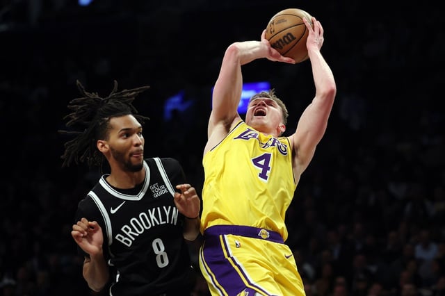 NEW YORK, NEW YORK - MARCH 10: Dalton Knecht #4 of the Los Angeles Lakers goes to the basket as Ziaire Williams #8 of the Brooklyn Nets defends during the second half at Barclays Center on March 10, 2025 in the Brooklyn borough of New York City. The Nets won 111-108. NOTE TO USER: User expressly acknowledges and agrees that, by downloading and or using this photograph, User is consenting to the terms and conditions of the Getty Images License Agreement. (Photo by Sarah Stier/Getty Images)