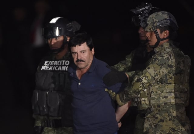 Drug kingpin Joaquin "El Chapo" Guzman is escorted by marines to a helicopter at Mexico City's airport on January 8, 2016 following his recapture during an intense military operation in Los Mochis, in Sinaloa State. (Image: OMAR TORRES/AFP via Getty Images)