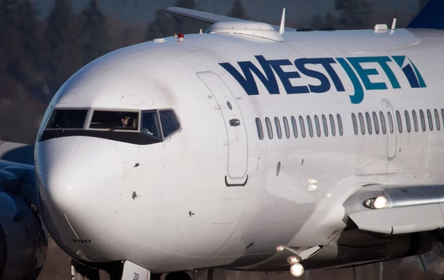 A pilot taxis a WestJet Boeing 737-700 plane to a gate after arriving at Vancouver International Airport in Richmond, B.C., on Monday, Feb. 3, 2014. THE CANADIAN PRESS/Darryl Dyck