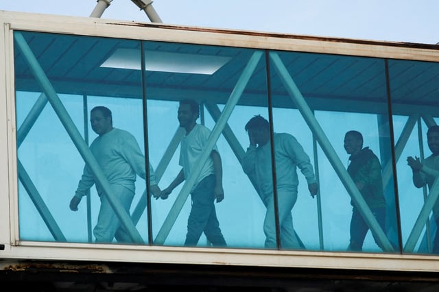 Venezuelan migrants react after arriving on a deportation flight from the United States at Simon Bolivar International Airport, in Maiquetia, Venezuela May 9, 2025. REUTERS/Leonardo Fernandez Viloria/File Photo