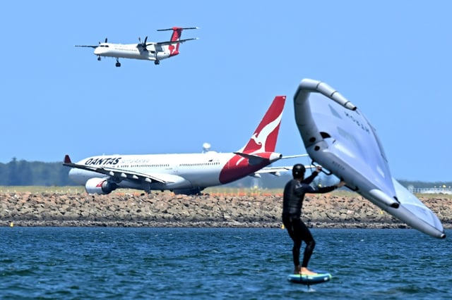 A Qantas plane waits to take off at Sydney International Airport