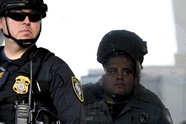 FILE - A DHS officer stands guard outside the Robert Young Federal Building during a march in solidarity for a peaceful interfaith Prayer Walk for Family Unity, June 18, 2025, in Los Angeles. (AP Photo/Wally Skalij, file)