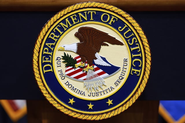 FILE - The U.S. Department of Justice logo is seen on a podium before a press conference with Attorney General Pam Bondi, Tuesday, May 6, 2025, at the Justice Department in Washington. (AP Photo/Julia Demaree Nikhinson, file)